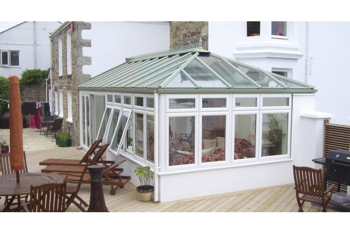 White Edwardian conservatory with Chartwell Light Green Roof