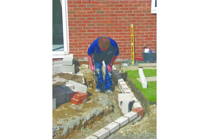 The external skin of the cavity wall is built to just below outside ground level.