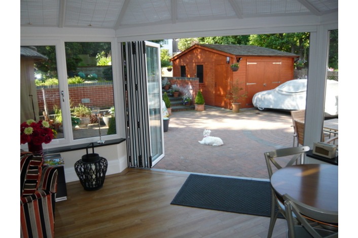 Internal view showing the use of folding sliding doors in a conservatory