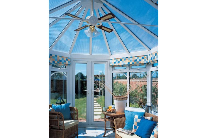 Internal view of conservatory with clear polycarbonate roof showing tie bar and fan