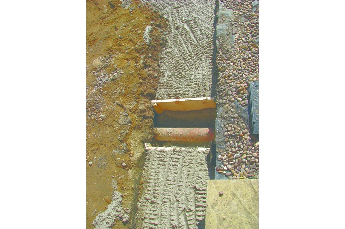 Existing drainage pipes are protected and bridged using concrete lintels.